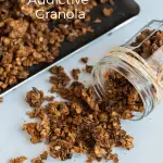A tray with granola and a jar with some granola on the table