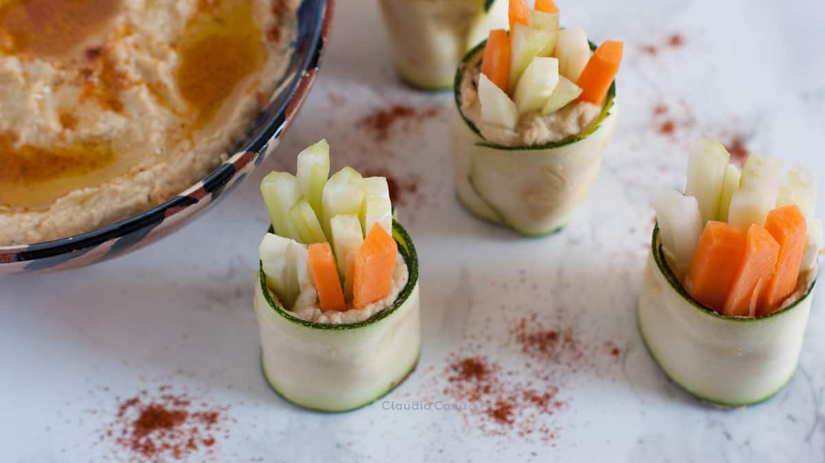 Zucchini roll ups with carrots, celery, cucumber and hummus. A healthy snack to eat more veggies.