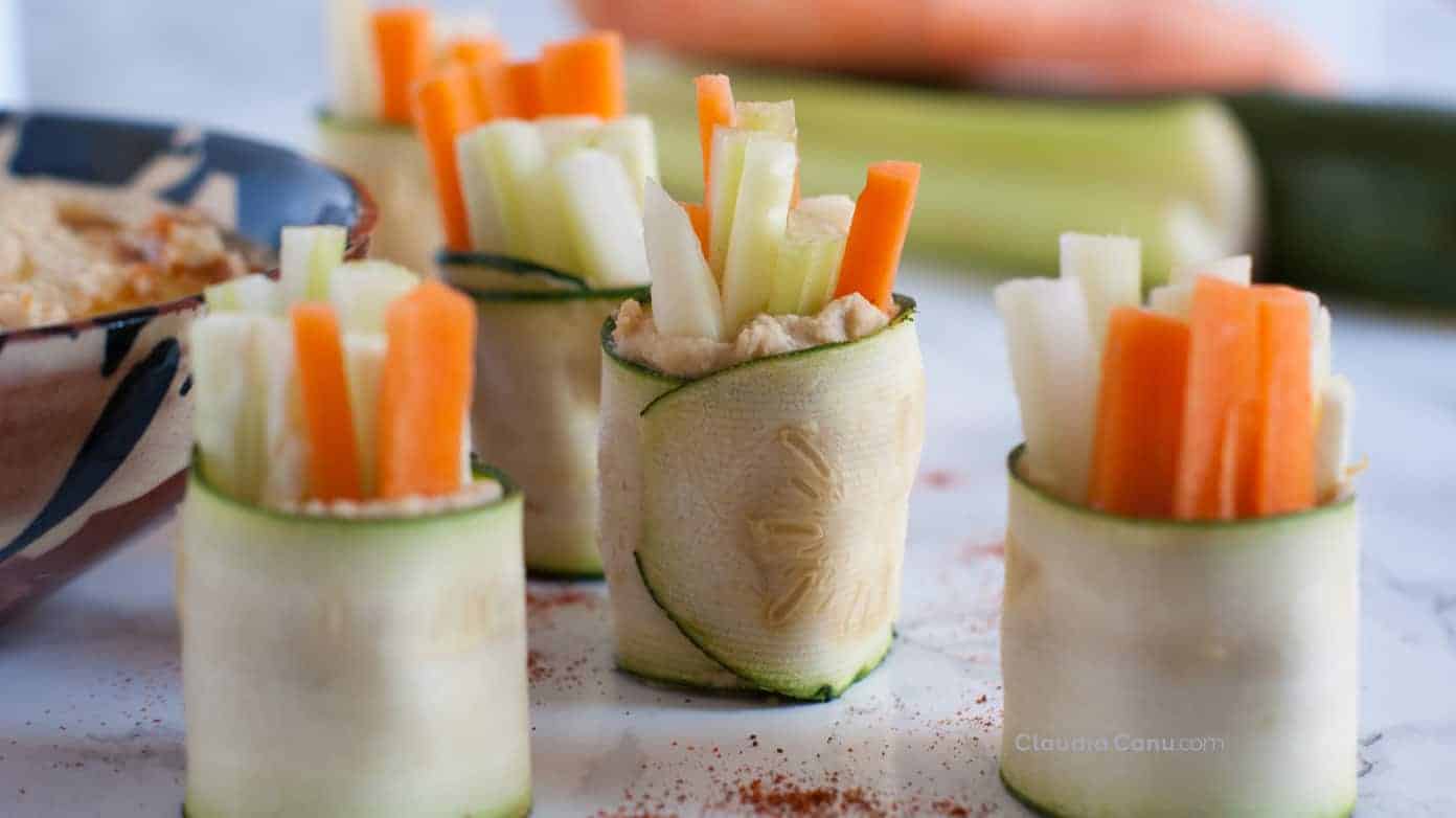 Zucchini roll ups with carrots, celery, cucumber and hummus. A healthy snack to eat more veggies.