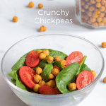Small salad with spinach, tomatoes and roasted chickpeas. More roasted chickpeas in the background