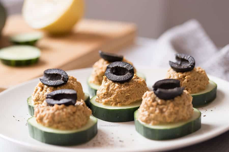Cucumber appetizers with sardine spread and an olive on top