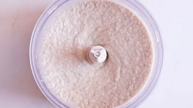 Food processor from the top with a white dough