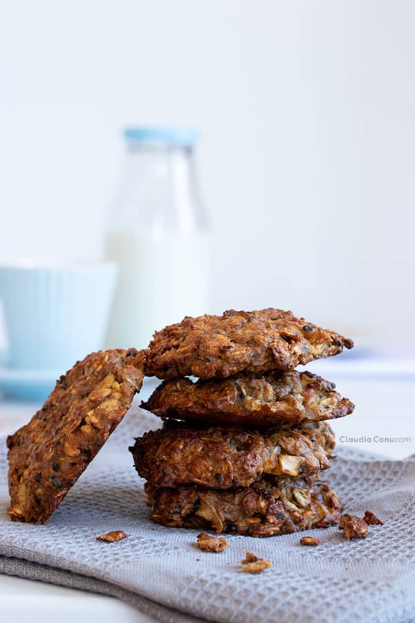 A pile of Oatmeal Cookies, a coffee mug and a bottle of milk