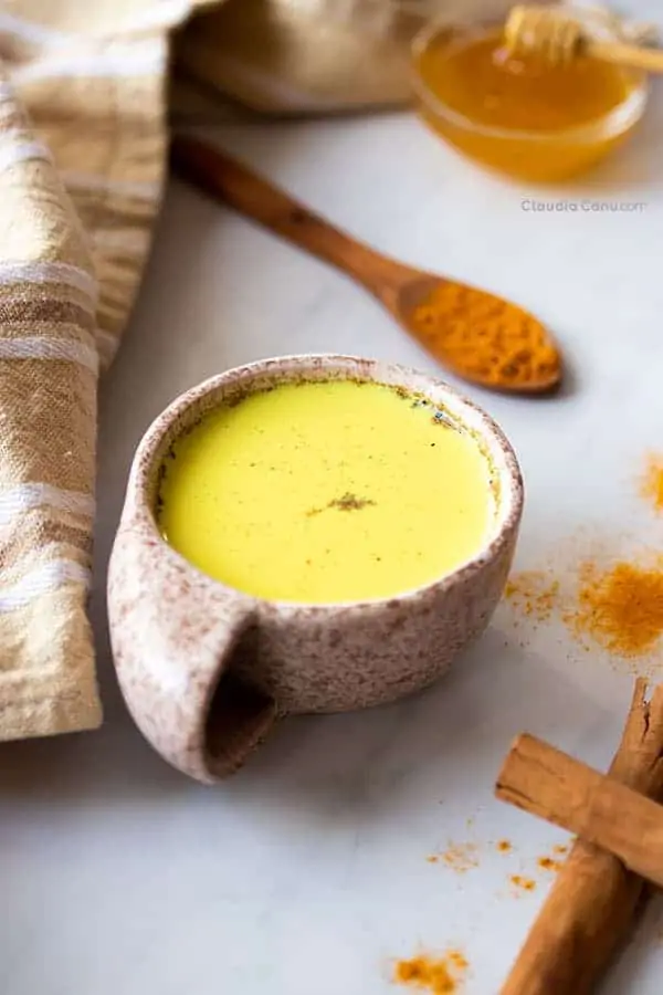 A mug with a yellow beverage called golden milk