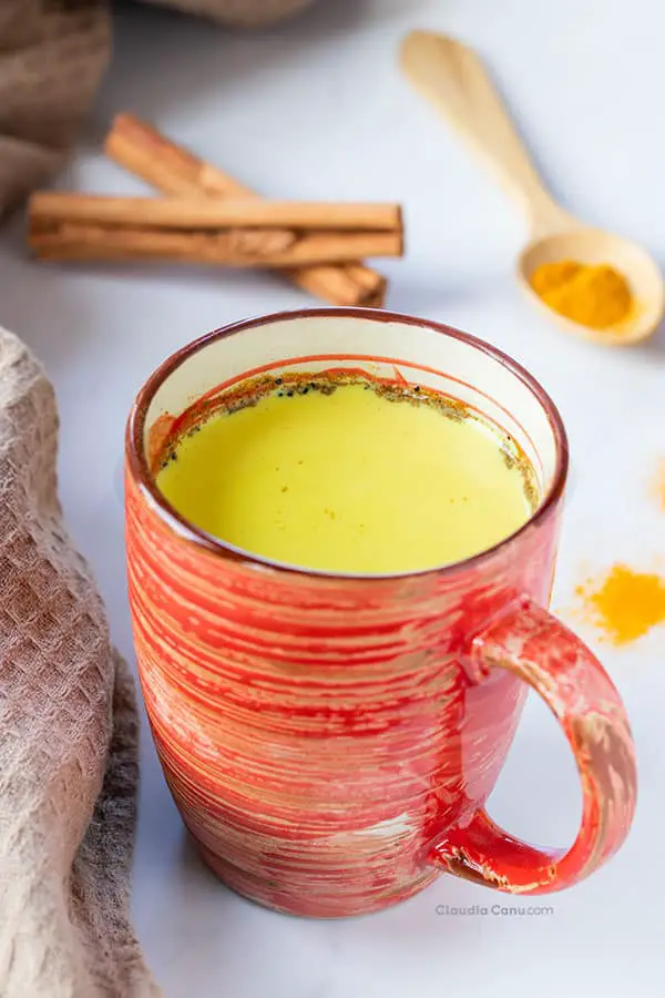 A mug with a yellow beverage called golden milk