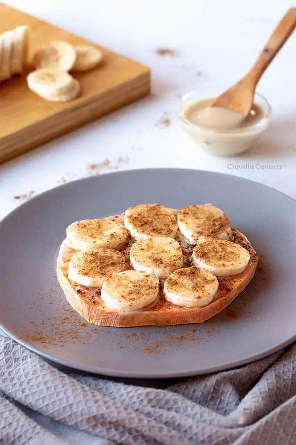 A plate with a sweet potato toast with banana and cinnamon