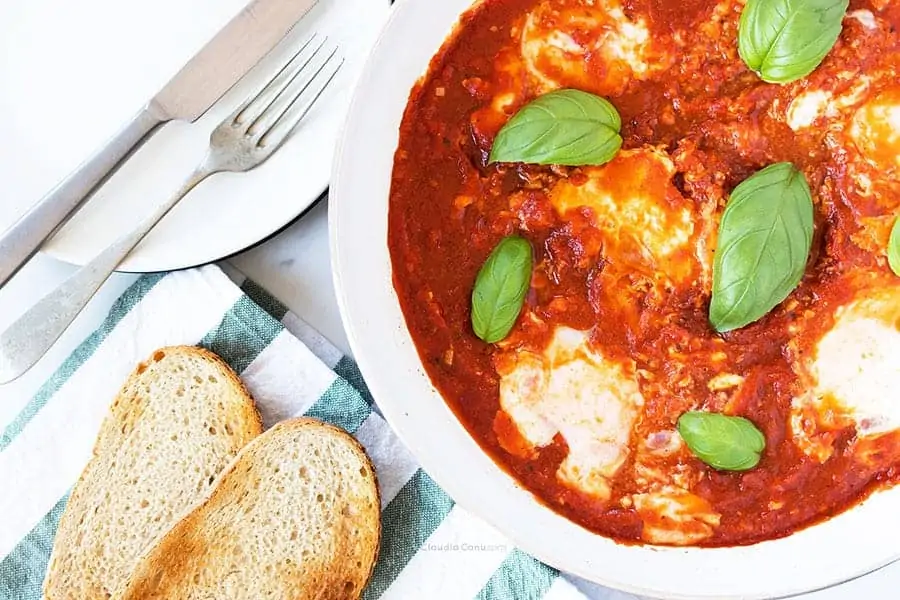 A pan with eggs in tomato sauce called eggs in Purgatory