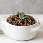 A white cocotte with wild rice in it
