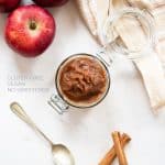Applesauce in a jar, red apples and cinnamon