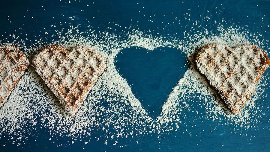 Pancakes in a heart shape with sugar on top