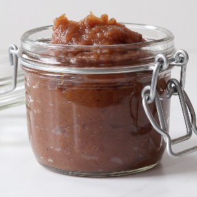 A glass jar full of applesauce
