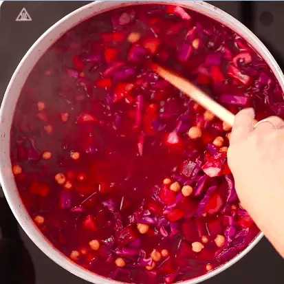 A pot with borscht with chickpeas cooking