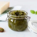 A jar with green pesto inside